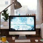 Contemporary home office desk with digital marketing screen, perfect for remote work inspiration.